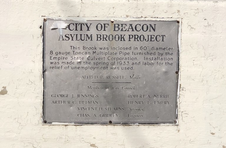 Photo of a plaque commemorating a stream burial